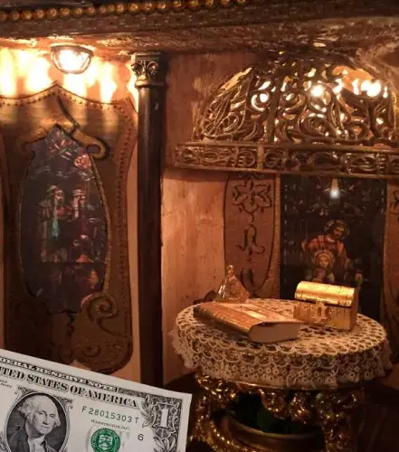 Gothic chapel interior with an ornate altar, shown with a dollar bill for scale